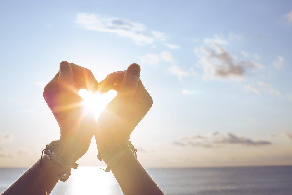 heart with hands at beach (c) shutterstock/Evdokimov_Maxim